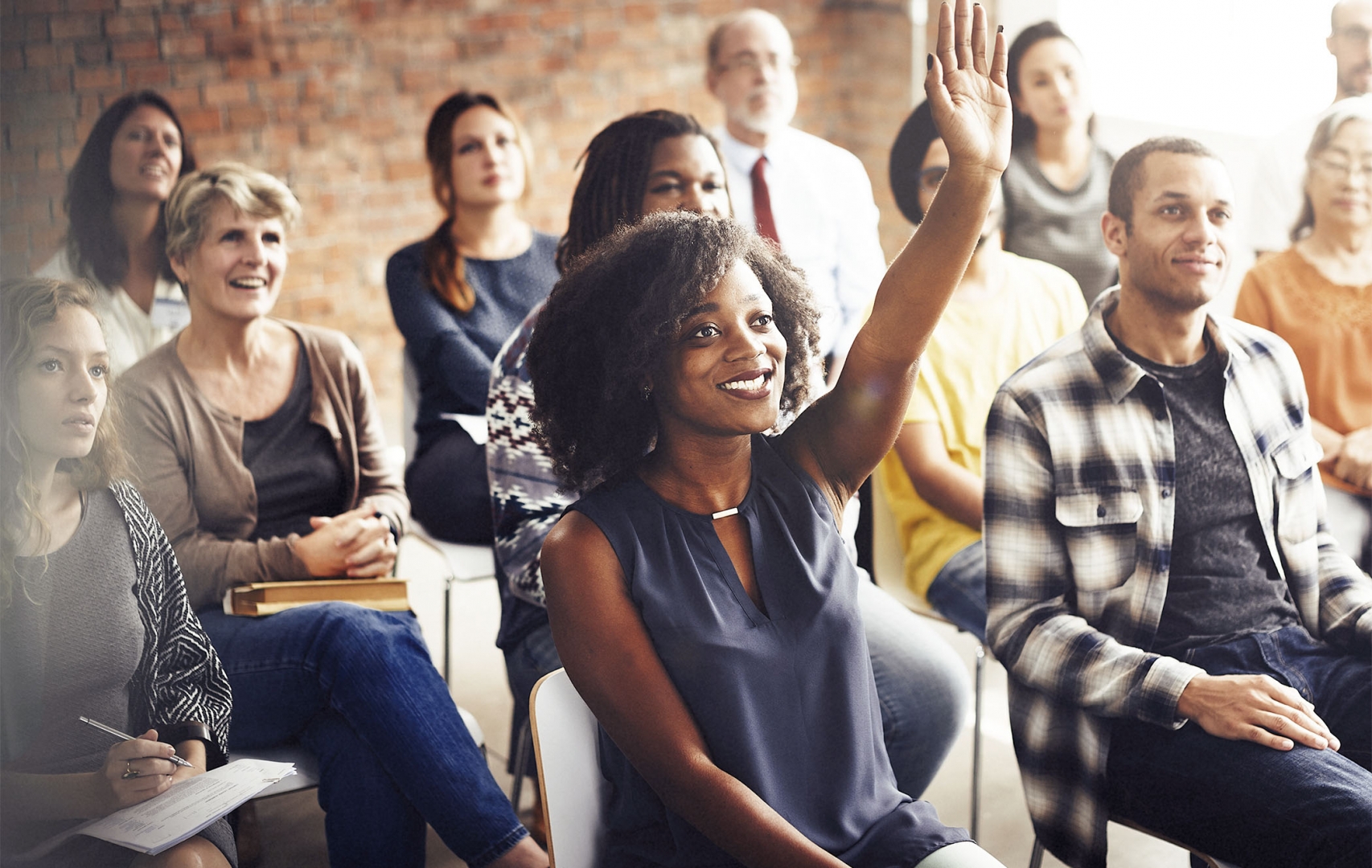 people in office raising hands