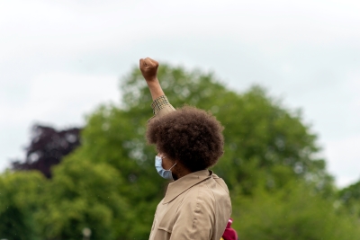african american male holding up fist wearing mask
