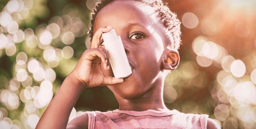 boy outside using inhaler