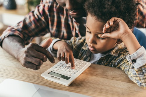 dad and son using calculator