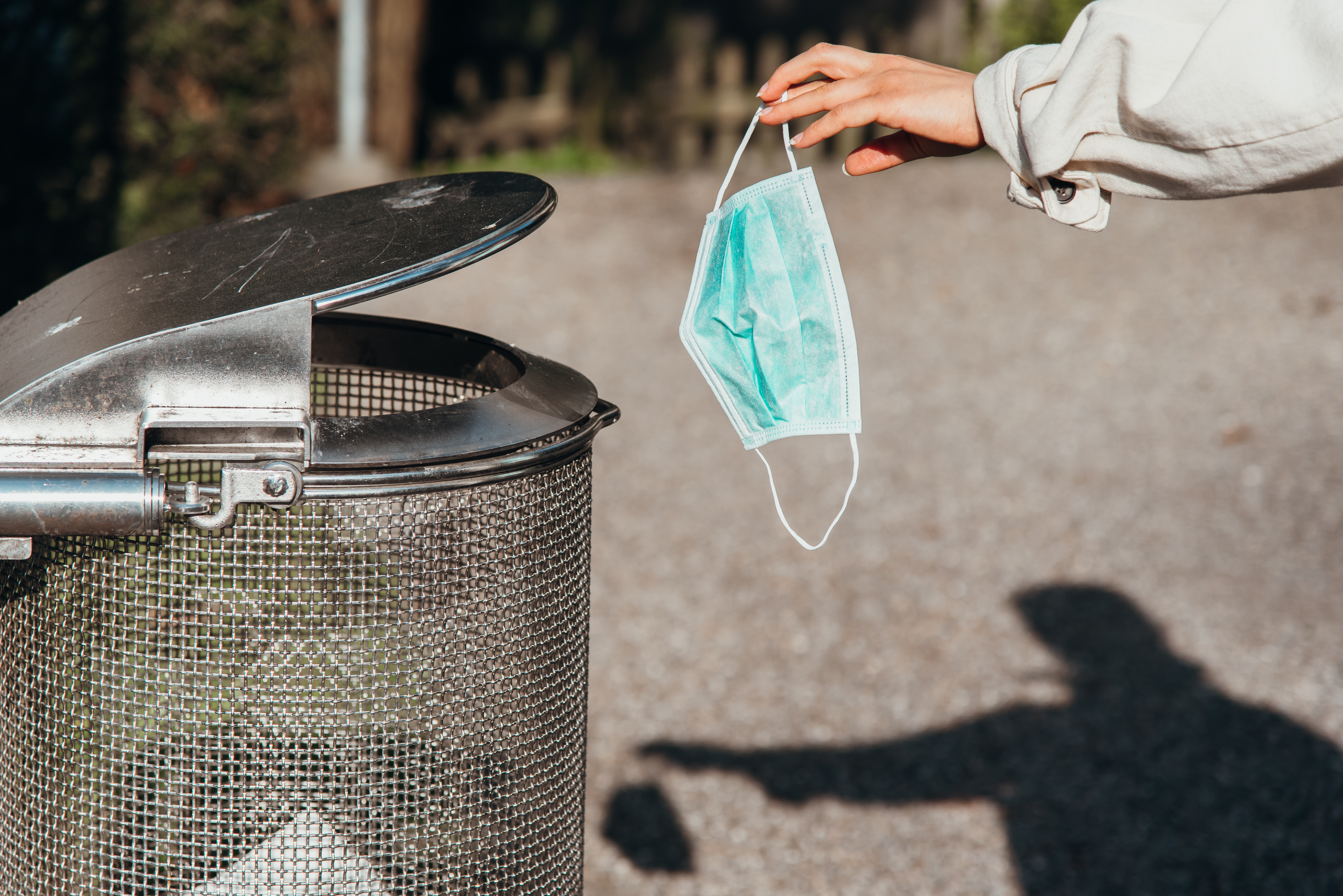 Person throwing away mask